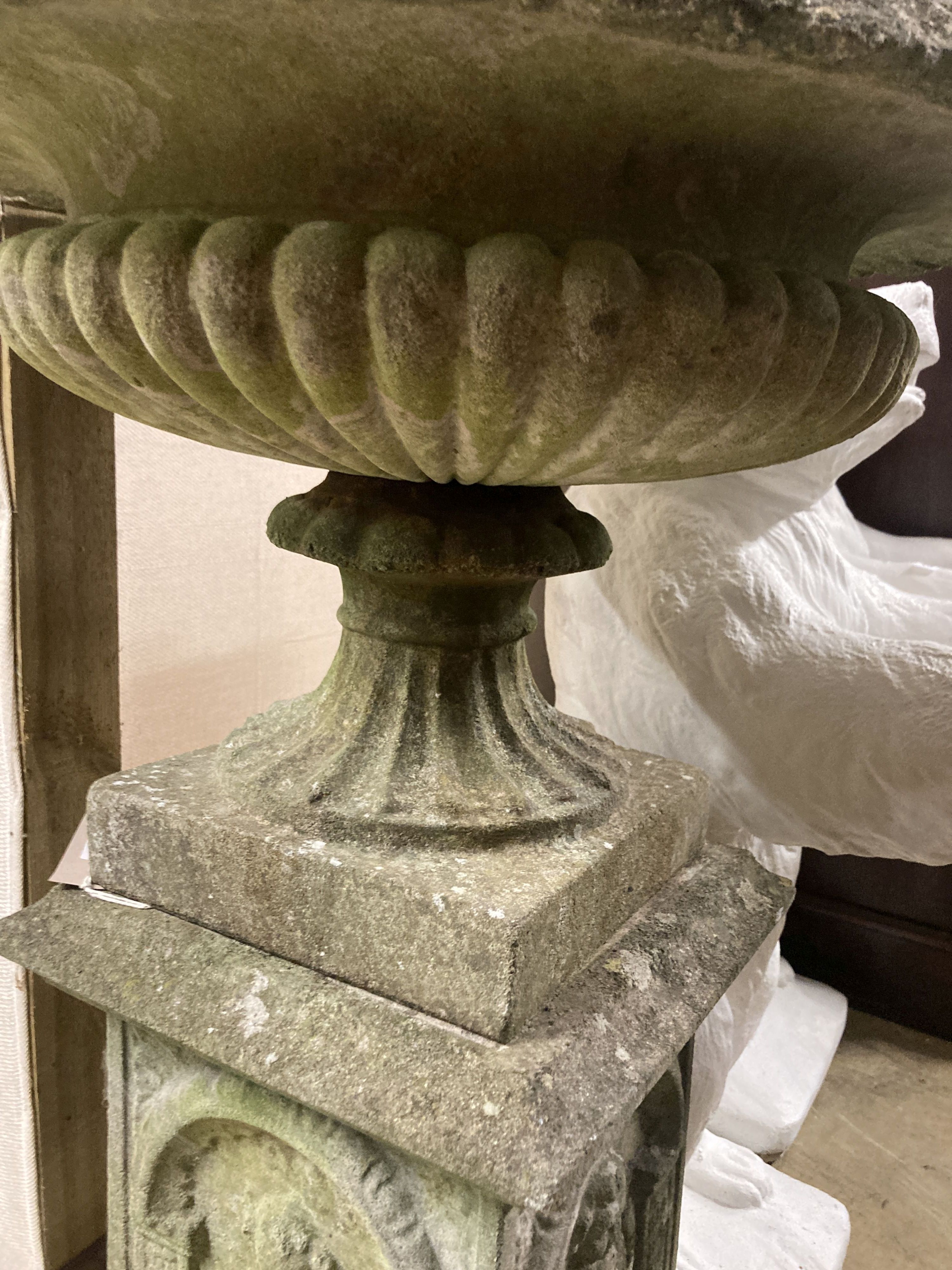 A reconstituted stone campana garden urn on pedestal, diameter 54cm, height 92cm